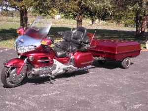 Candy apple red 2003 Honda Goldwing with matching luggage trailer.
