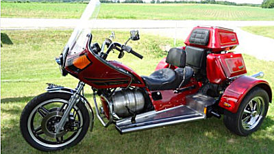 Custom VW trike motorcycle w Jewel Red paint 1600CC VW motor, a 4 SPEED transmission with reverse, disc brakes, SS steel running boards, an electronic ignition, a trailer hitch and side suitcases (this photo is for example only; please contact seller for pics of the actual motorcycle for sale in this classified)