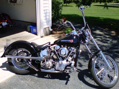 1950 Harley Davidson FL Panhead w rigid Santee wishbone motorcycle frame, a Harley Wide glide front end, HD heads and cases, a Midwest 4 speed transmission, disc brakes, a 3 inch open belt primary and an S&S carb (this photo is for example only; please contact seller for pics of the actual motorcycle for sale in this classified)