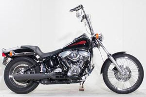 1999 Harley Davidson Softail Standard w Vivid Black Paint, Badlander motorcycle seat and steel laced wheels.