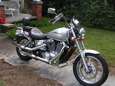 2007 Honda Shadow Spirit 1100 w silver paint color, backrest, engine guards and a luggage rack