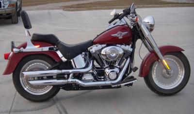 Burgundy Harley Fatboy Motorcycle w slash-cut exhaust pipes with Screamin Eagle tips 