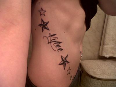 Sweet n Sexy Nautical Star curved on my ribs in plain black ink  w my daughter's name in the design!