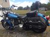 Blue 2011 Harley Heritage Softail with custom exhaust pipes